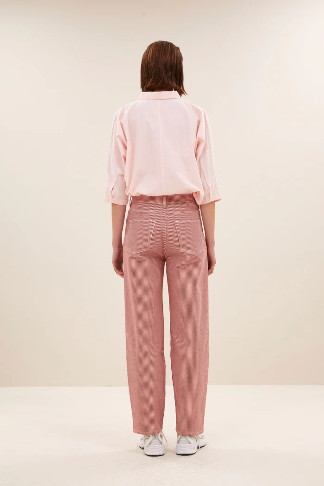 Model wearing the By-Bar norel chambray blouse in light pink. Back view