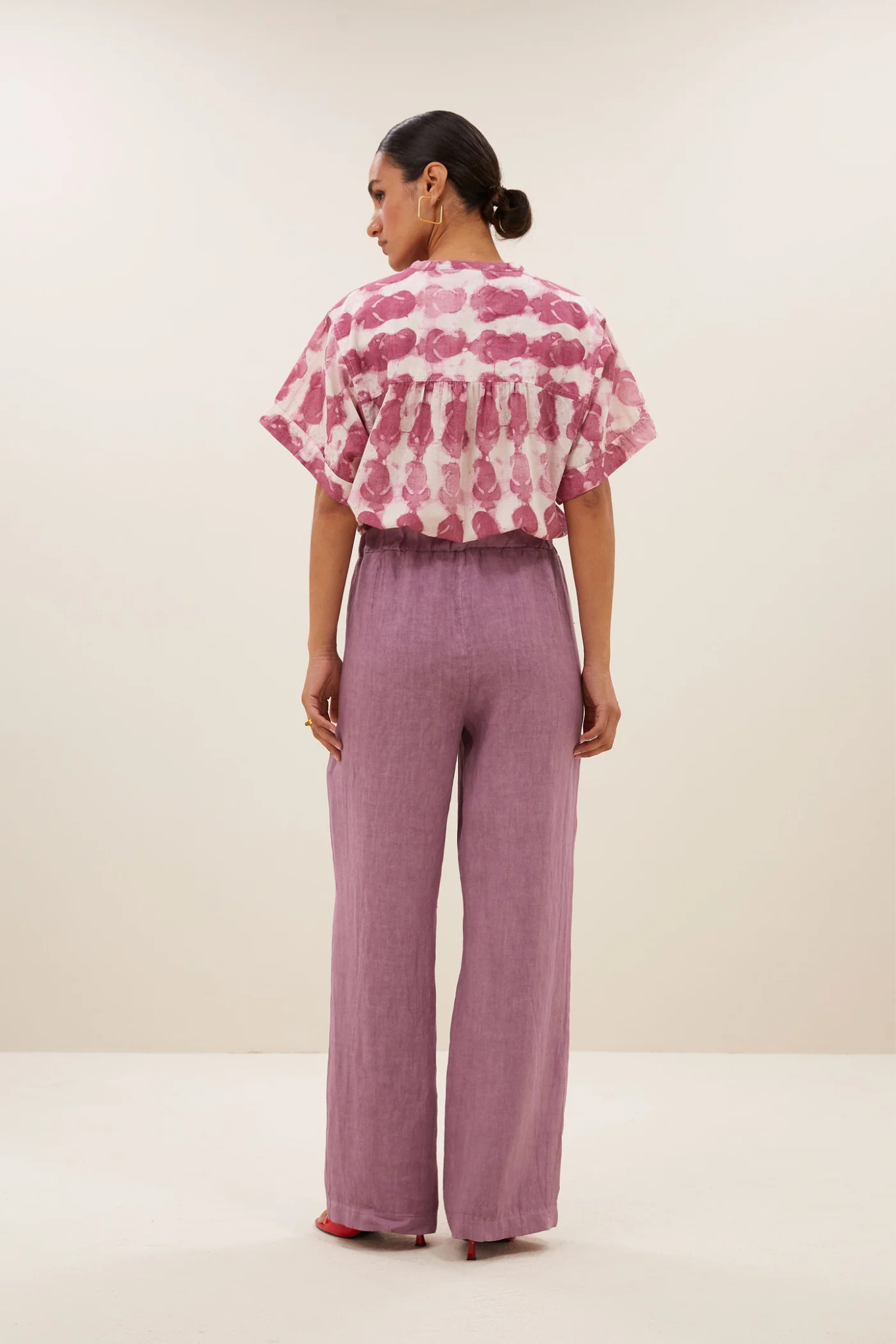 Model wearing the By-Bar robyn linen pants in lavender. Back view