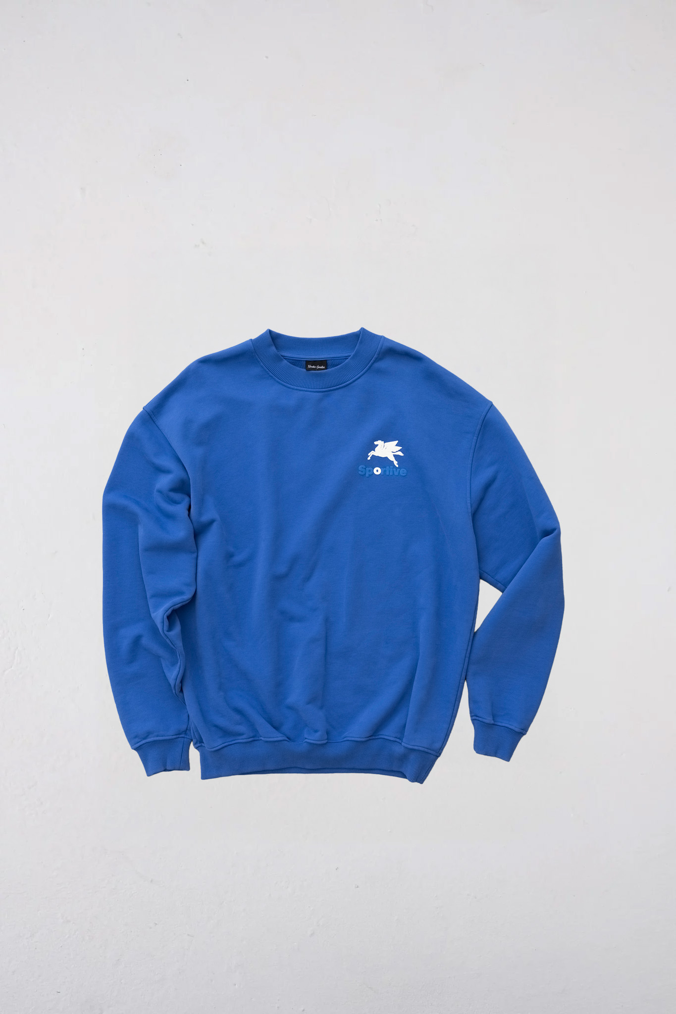 Goodies Sportive crewneck sweater in blue and logo in white. Front flatlay view