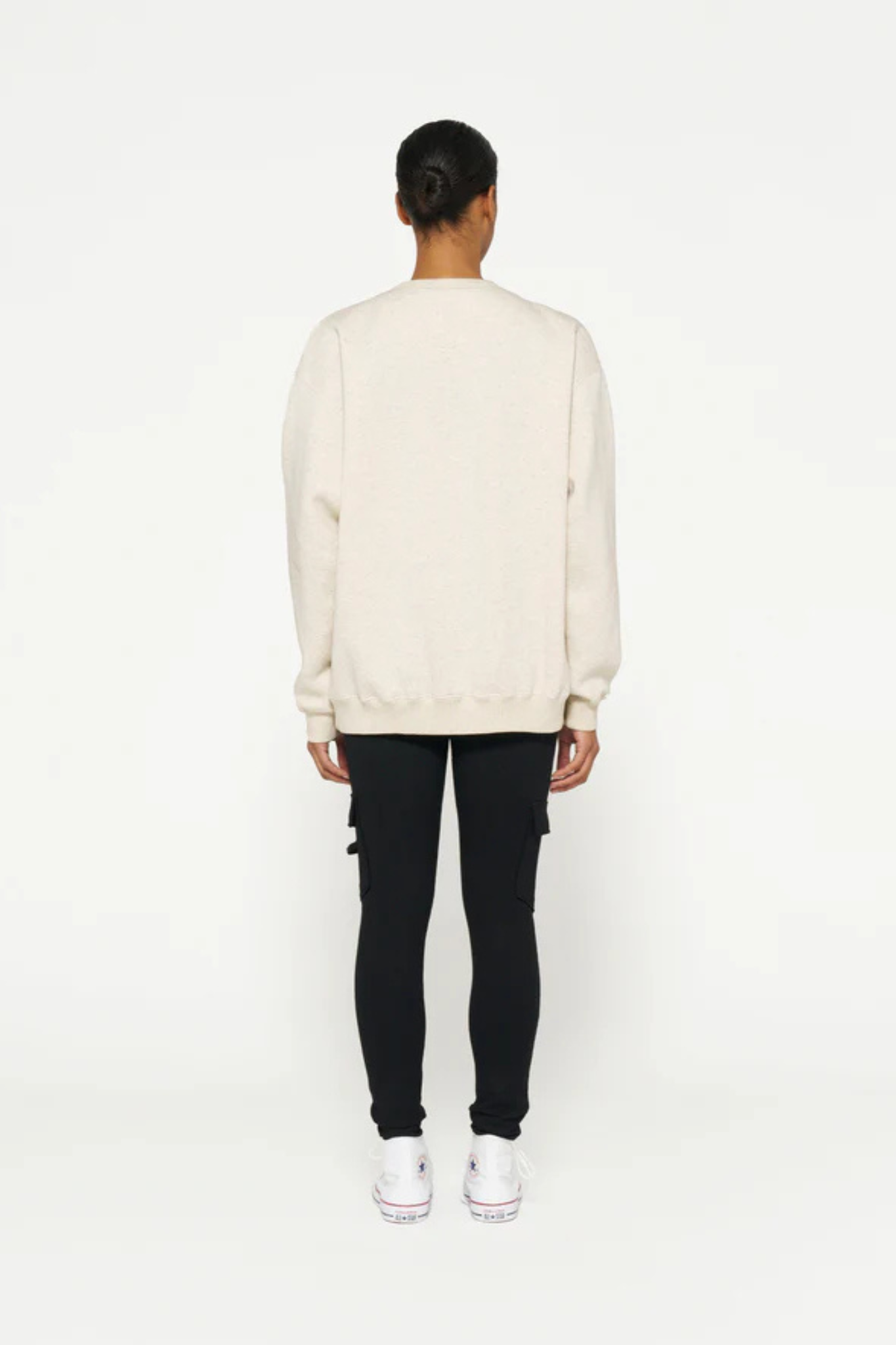 Model wearing the 10DAYS statement sweater in soft white melee. Back view