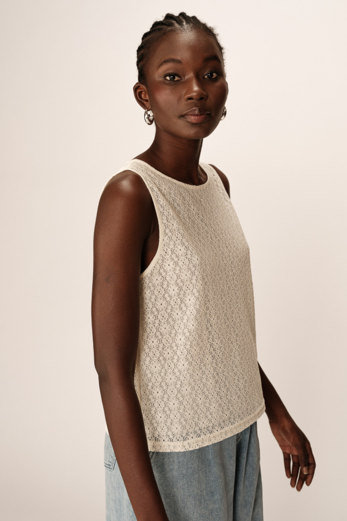 Model wearing the Grace & Mila passionnee top in ecru. Side view