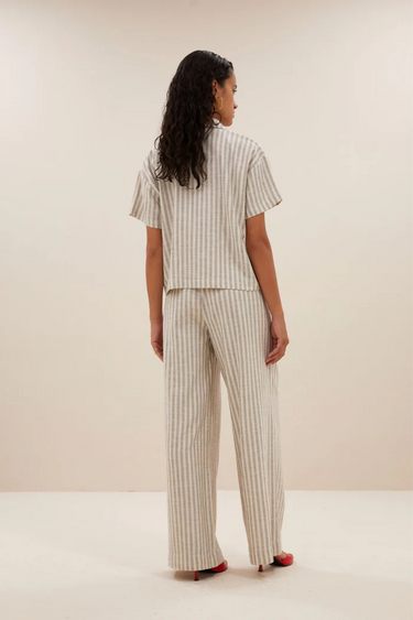 Model wearing the By-Bar Benji striped marine pants in beige and white. Back view