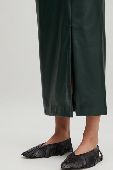 Model wearing the Edited Florin skirt in green. Close front view