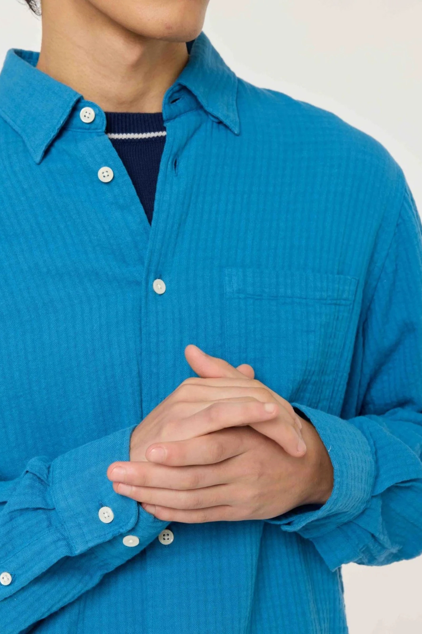 Model wearing the Castart konga shirt in bright blue. Front view