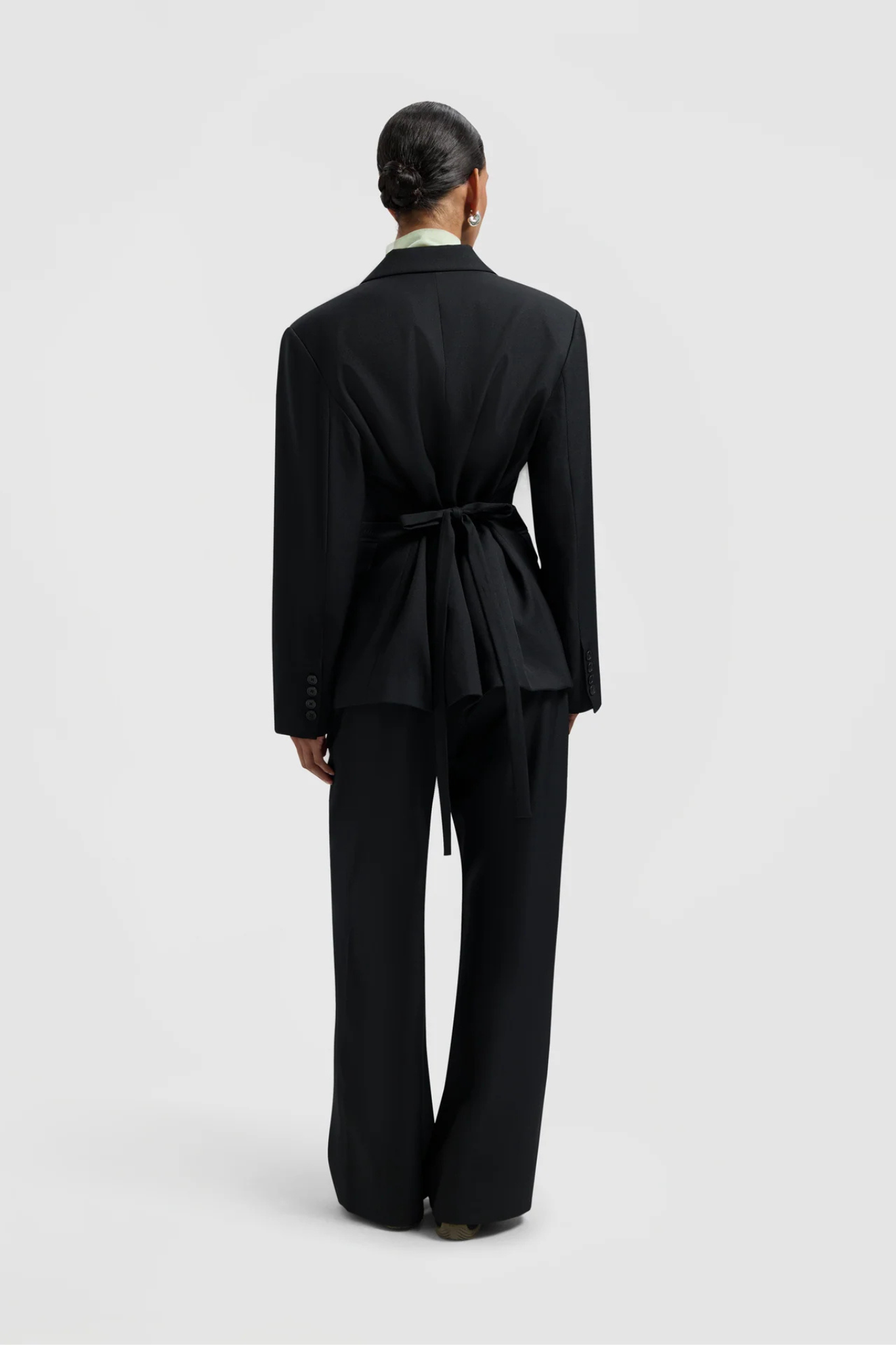 Model wearing the Olaf tailored blazer in black. Back view