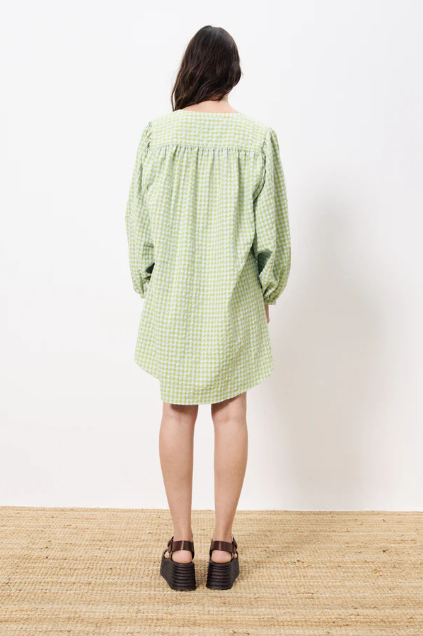 Model wearing the FRNCH noely dress in green checked. Back view