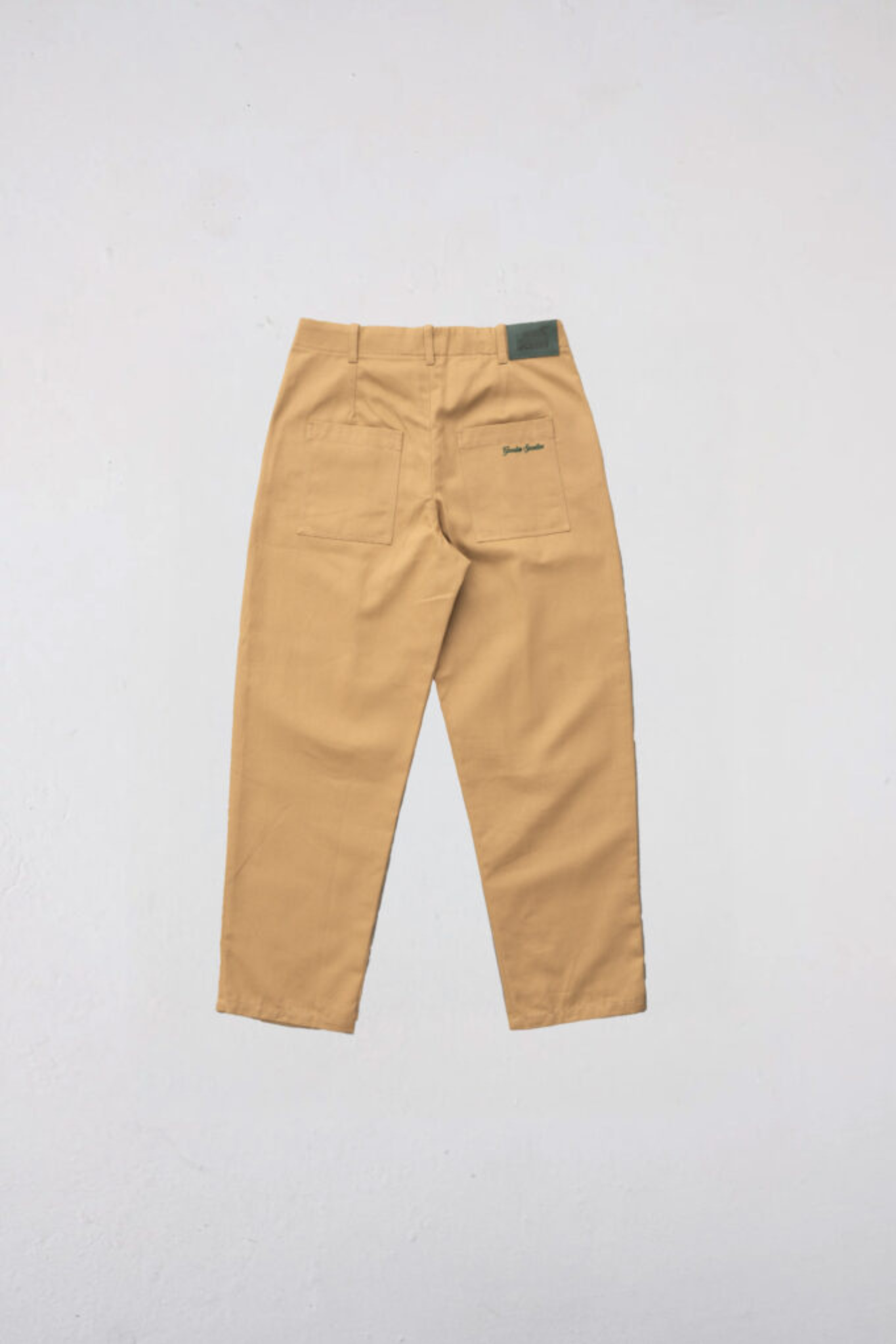 Goodies Sportive heritage chino pants in brown. Back flatlay view