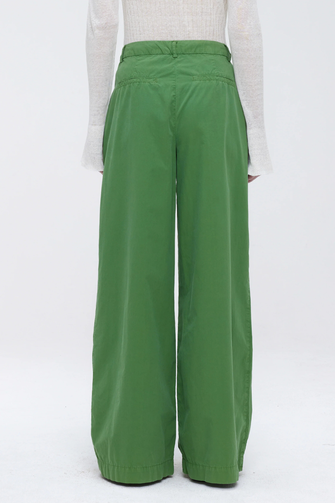 Model wearing the Our Sister Pansmokeyc pants in green. Back view