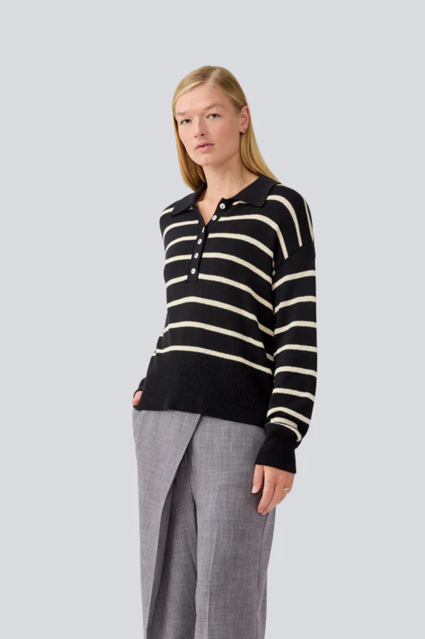 Model wearing the Modstrom malva striped polo sweater in black and white. Front view