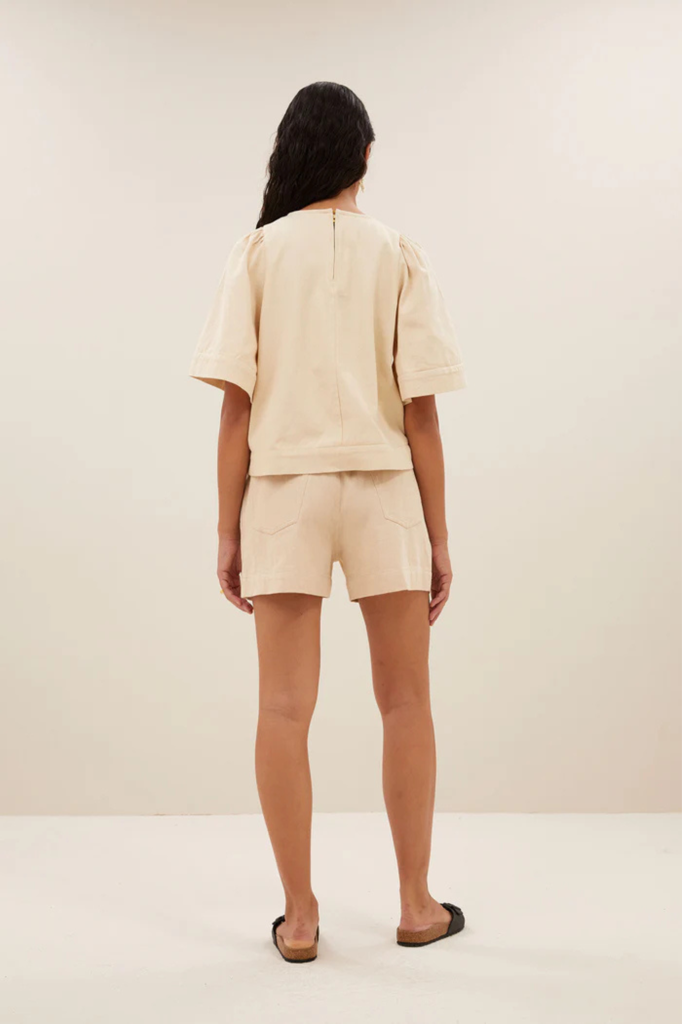 Model wearing the By-Bar olivia twill blouse in grain beige. Back view