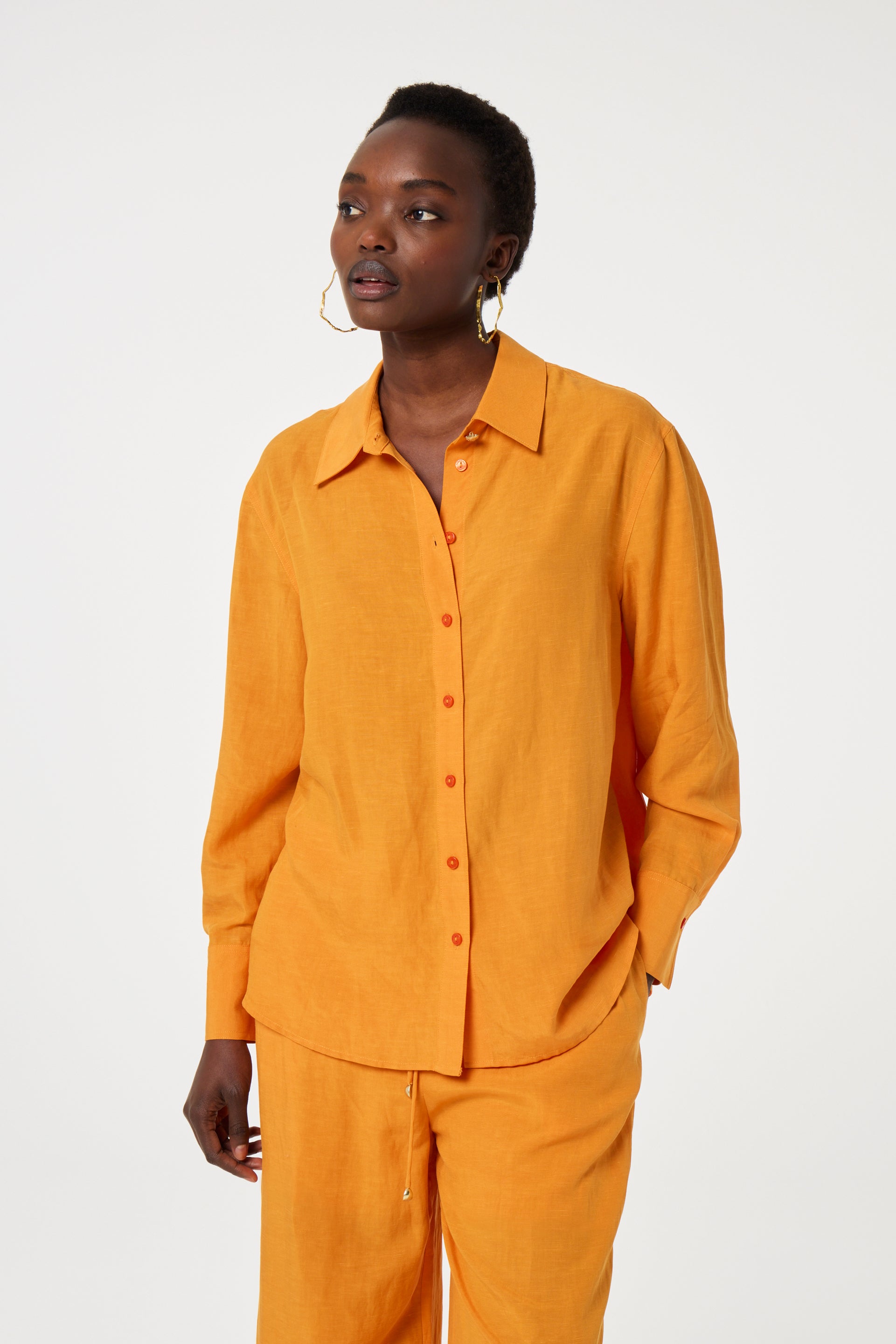 Model wearing the Fabienne Chapot tony blouse in orange. Front view