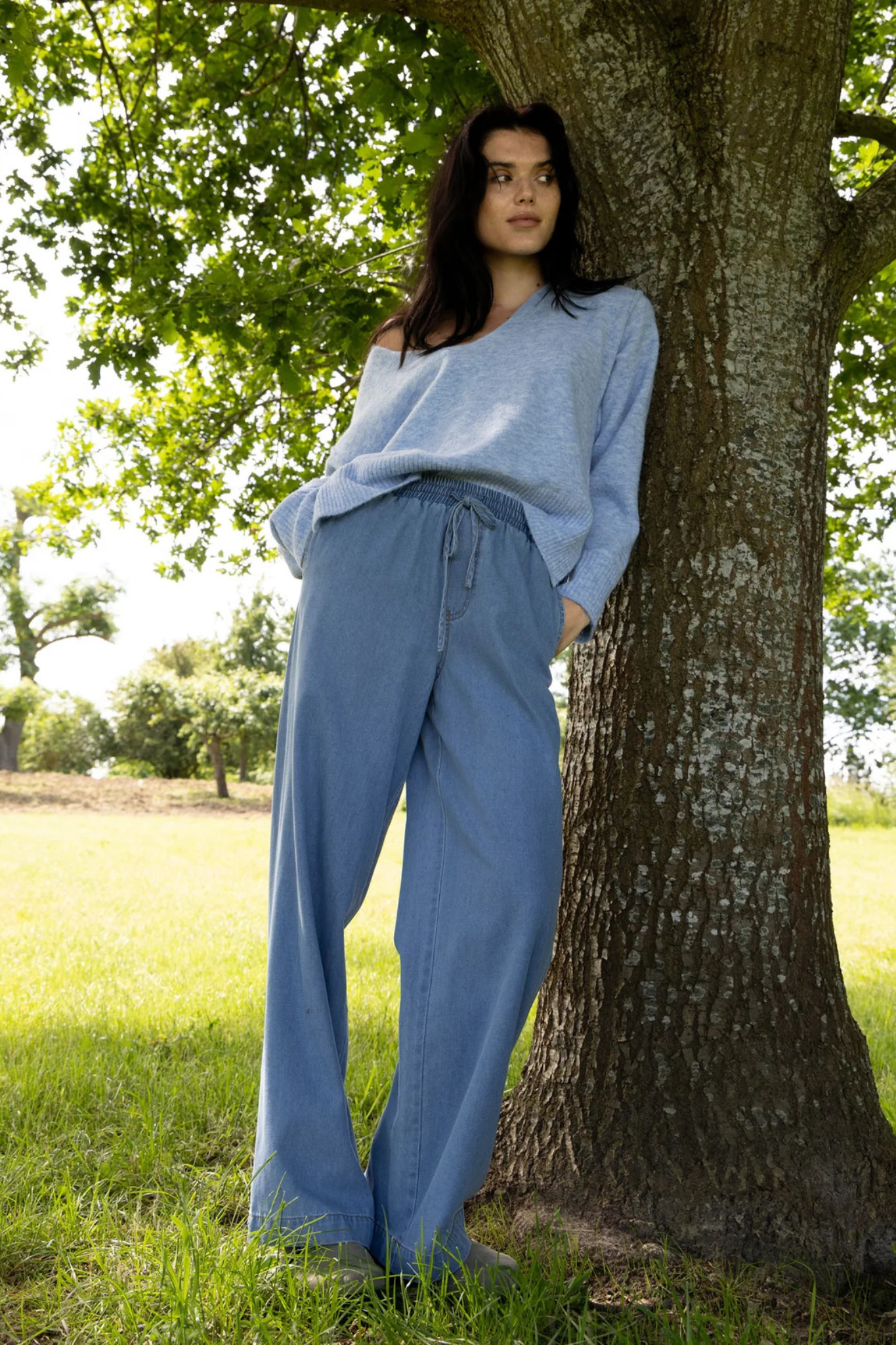 Model wearing the CC Heart ellis denim pants in blue denim. Front view