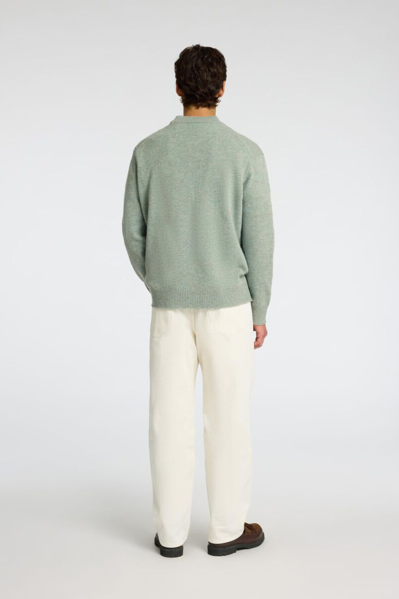 Model wearing the Selected Homme reuben ls knit relaxed crewneck in green. Back view