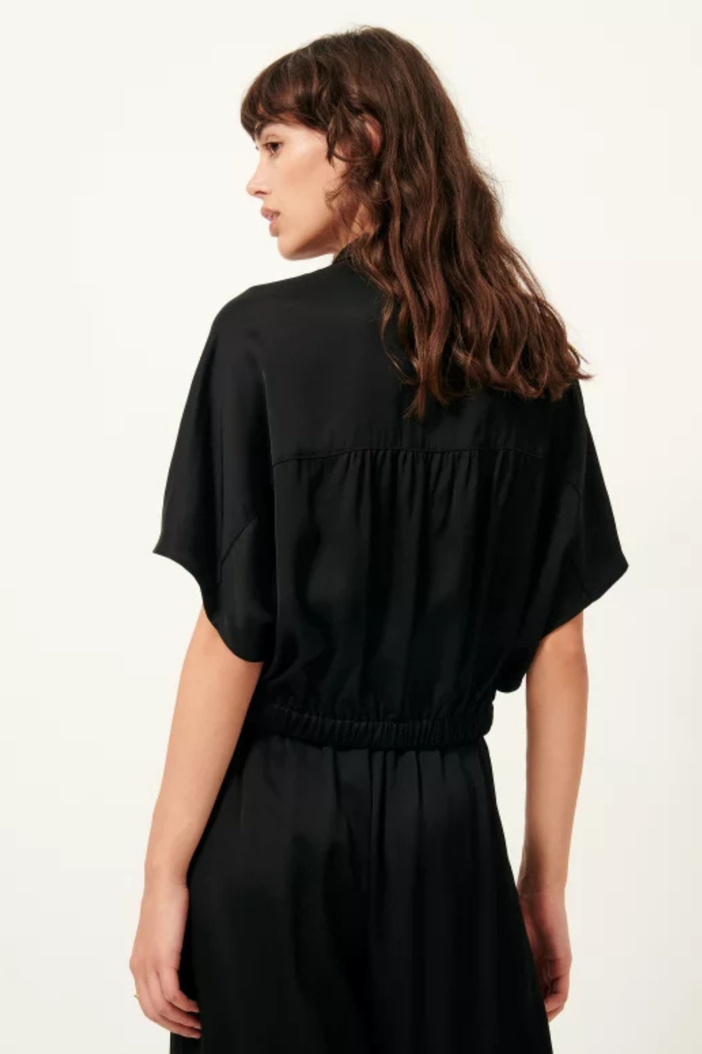 Model wearing the Sessun alfassa night tied blouse in black. Back view