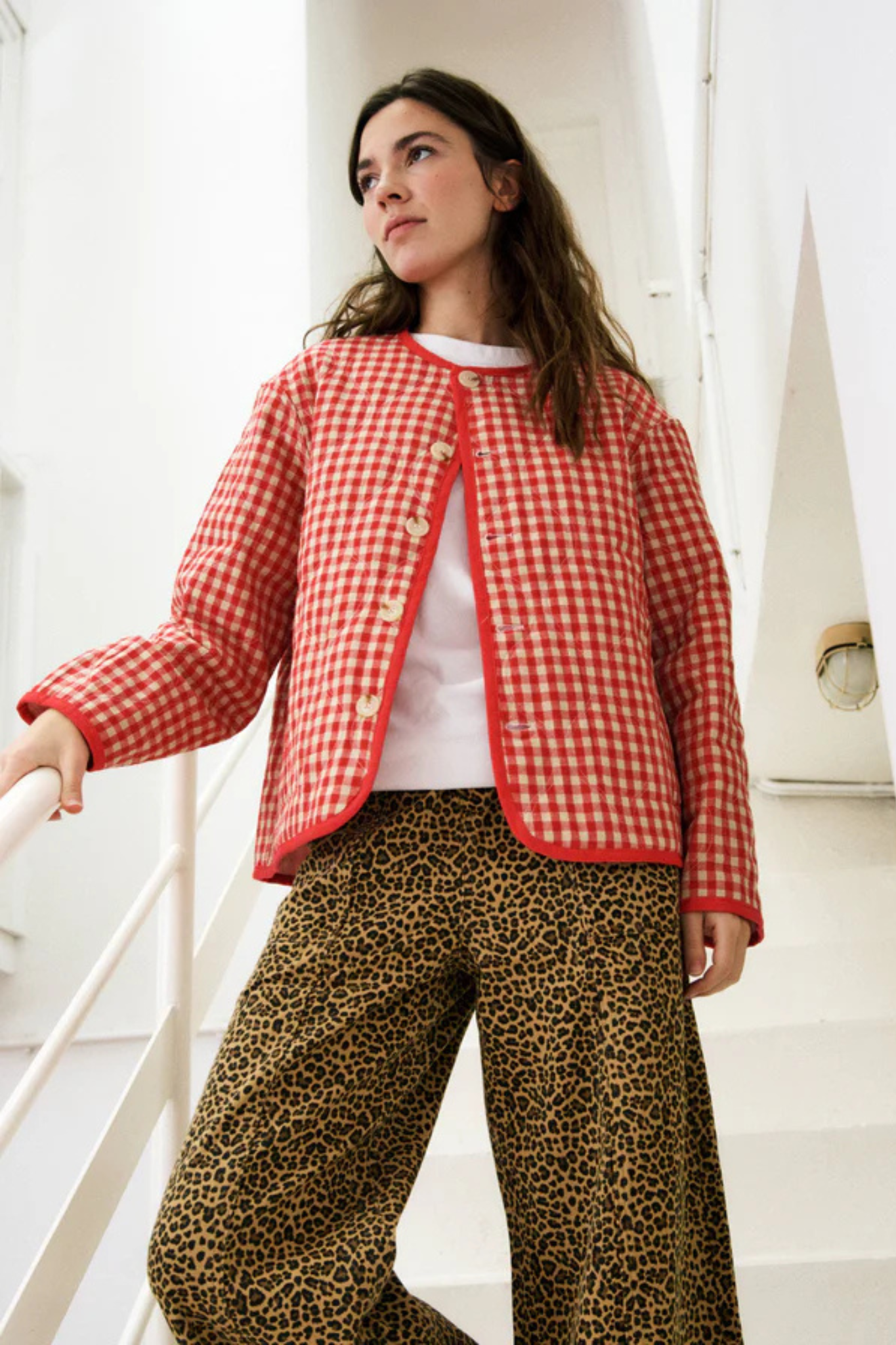 Model wearing the FRNCH alezia jacket in pink and red checked. Front view