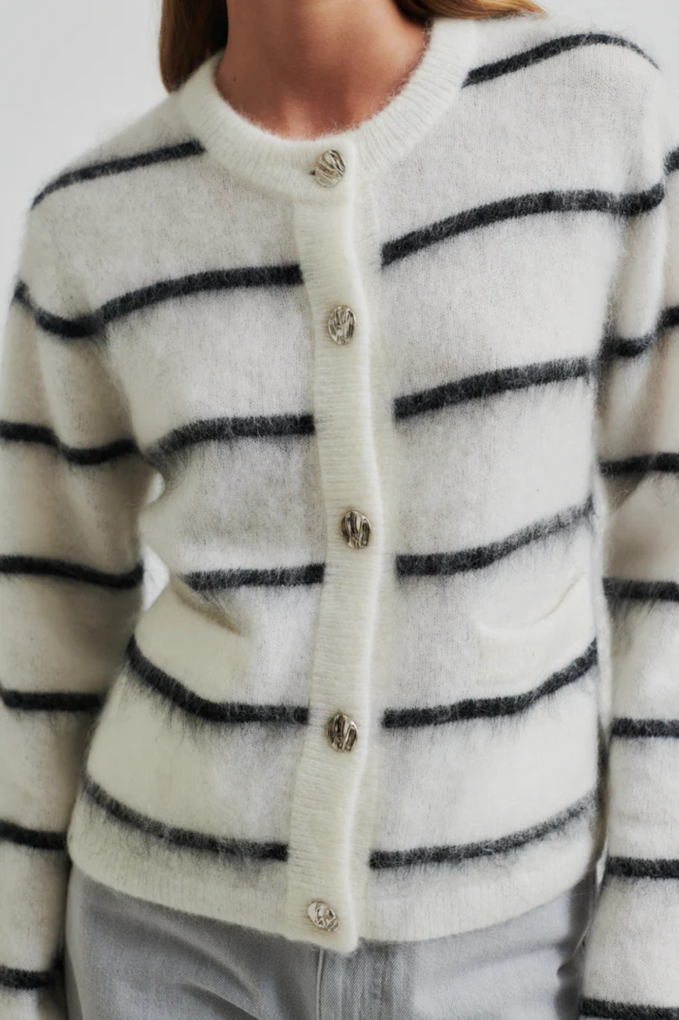 Model wearing the Second Female ovalina knit cardigan in striped white and black. Front view