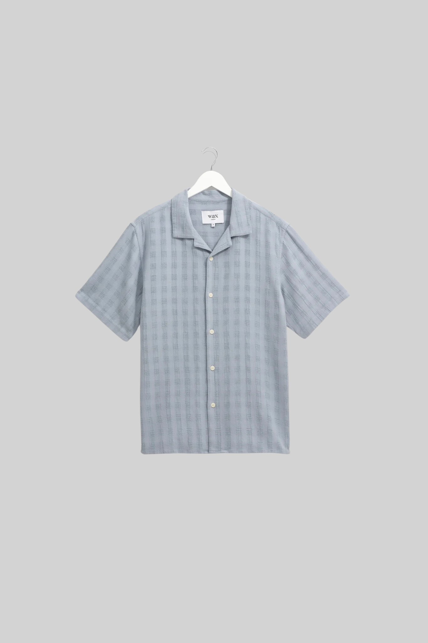 Wax London didcot box open weave grid shirt in pale blue. Front flatlay view 