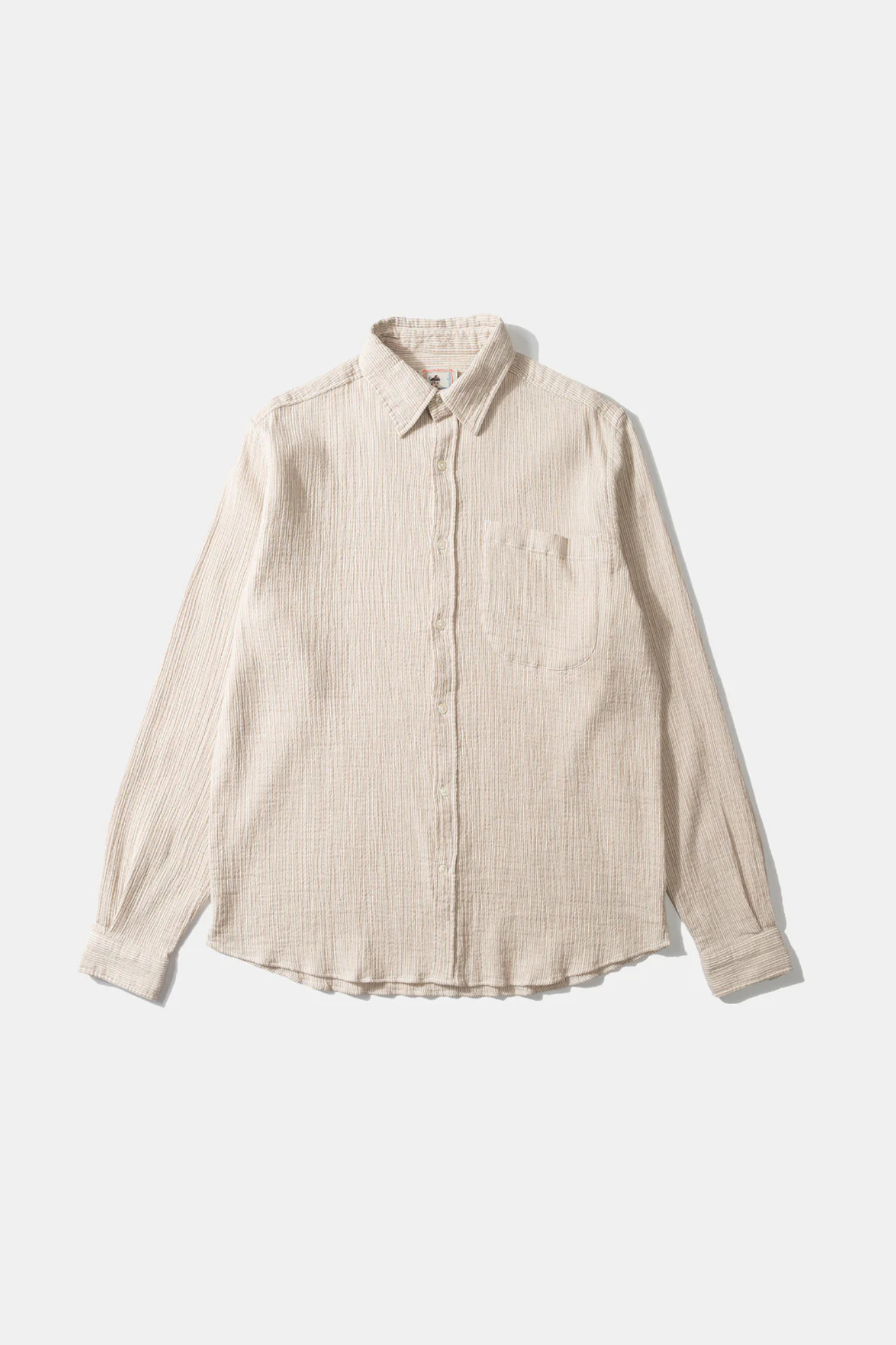 Edmmond Studios snap stripes shirt in plain beige. Front flatlay view