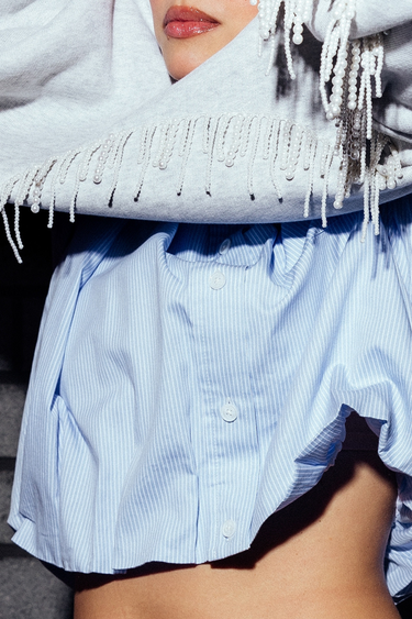 Model wearing the Catwalk Junkie tuck in blouse in blue. Front close view