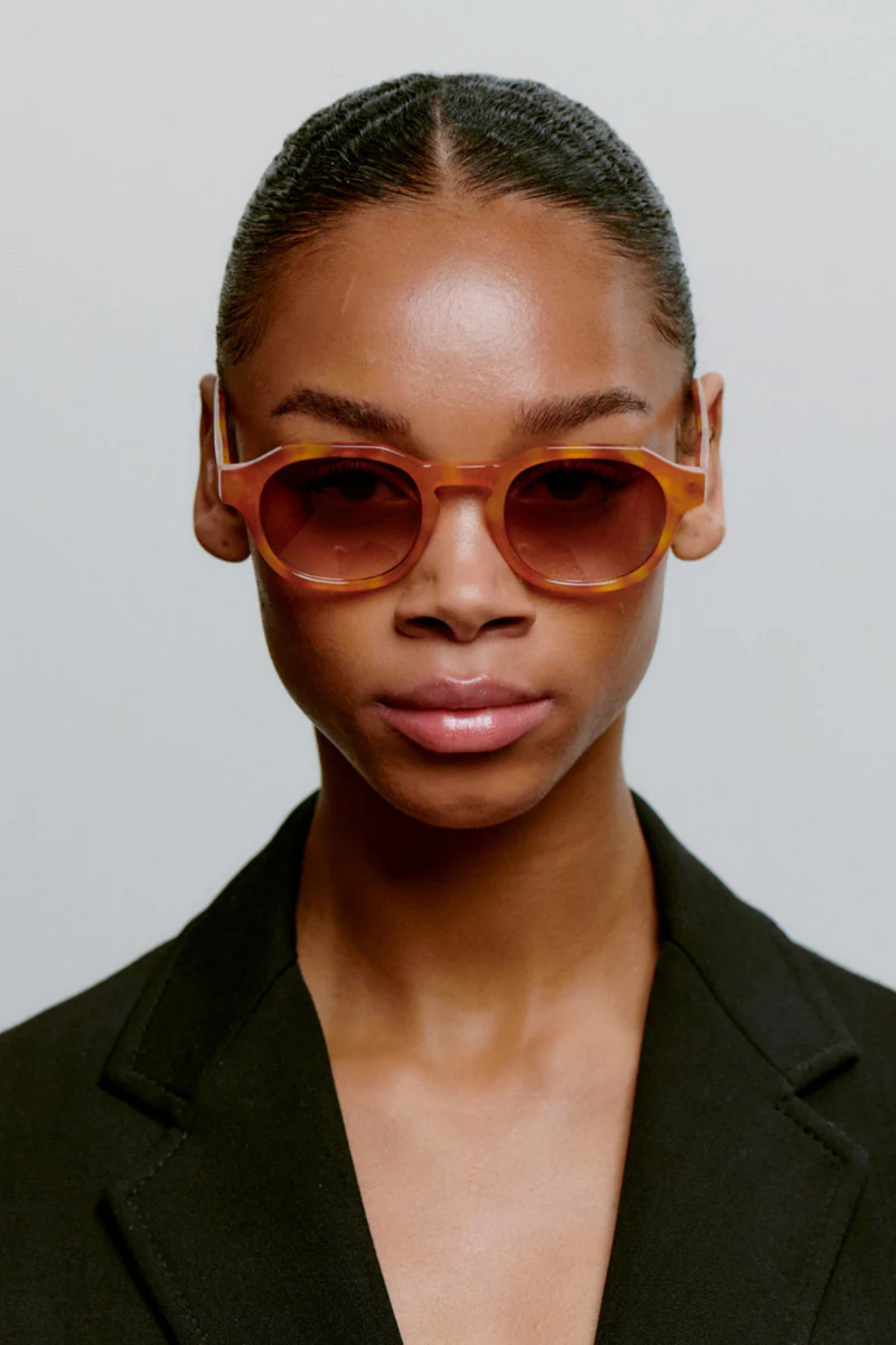 Model wearing the A. Kjaerbede zan sunglasses in burnt amber / orange. Front view