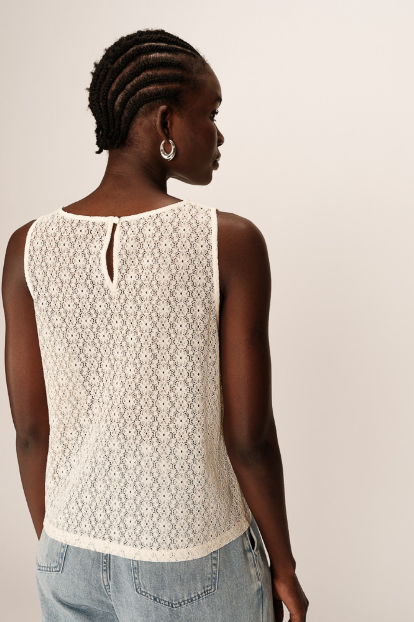 Model wearing the Grace & Mila passionnee top in ecru. Back view