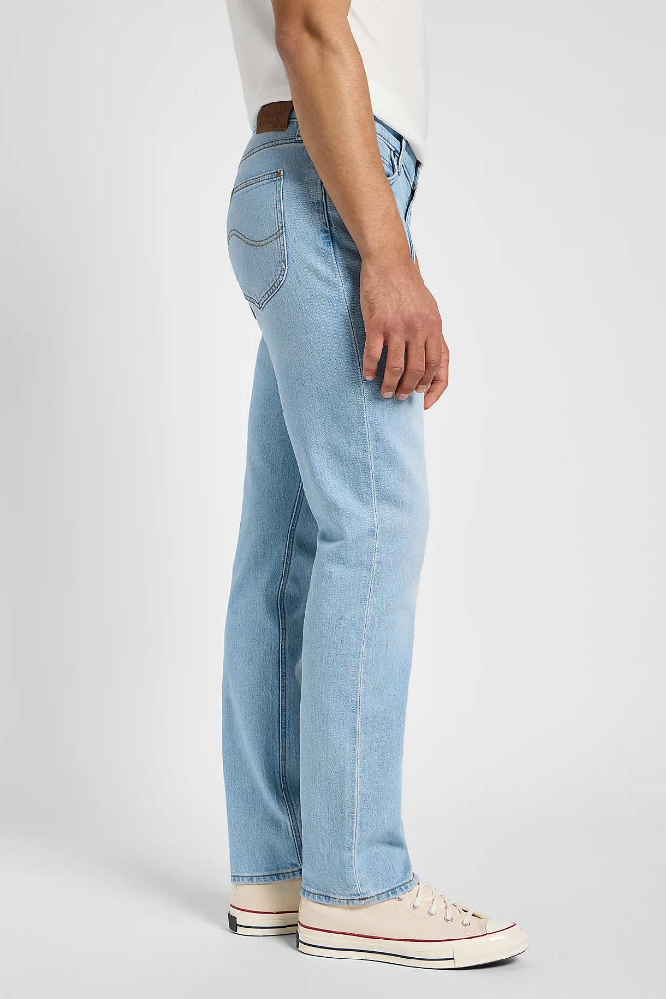 Model wearing the Lee west jeans in light blue. Side view