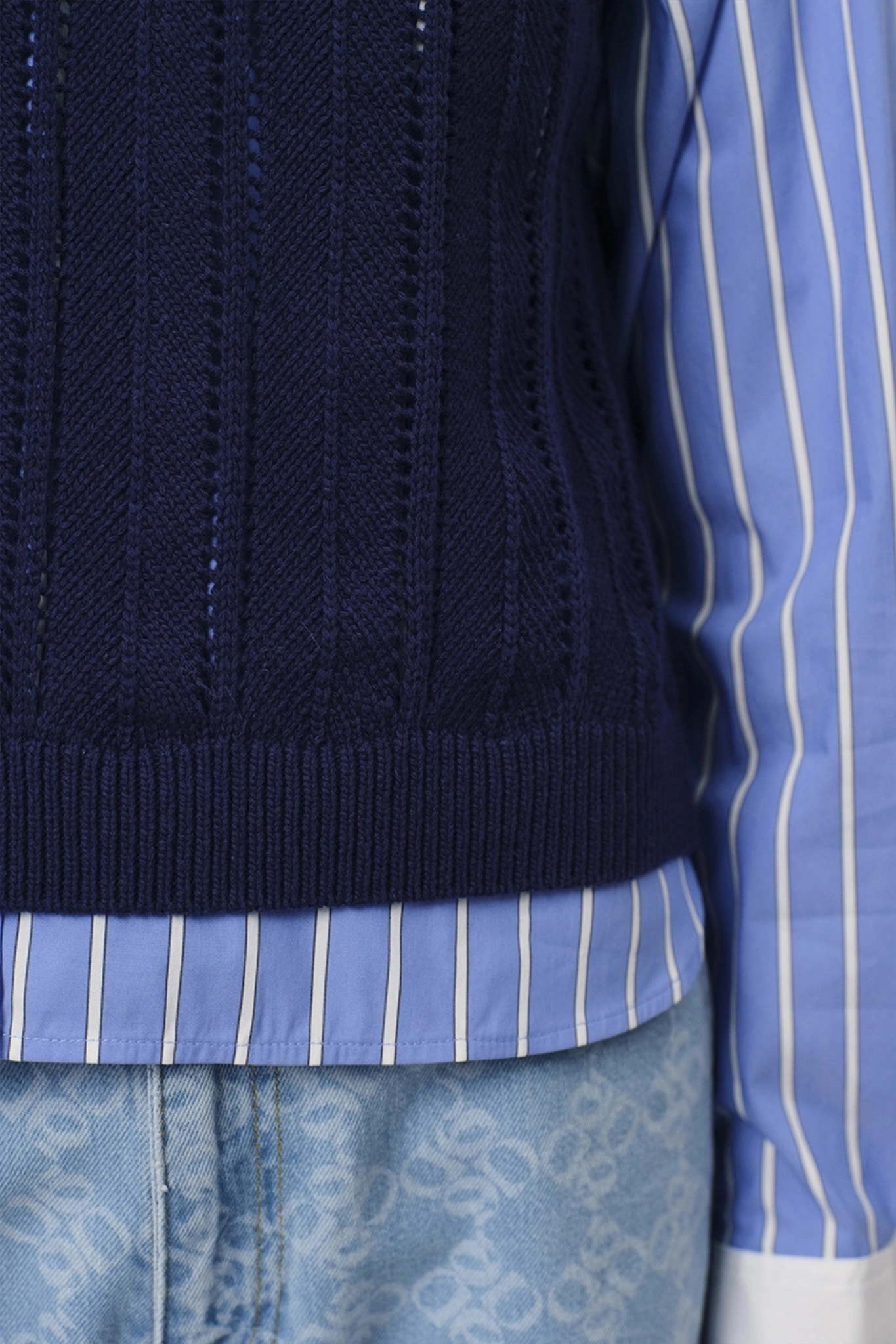 Model wearing the Dante6 blake sleeveless open back sweater in blue. Close view