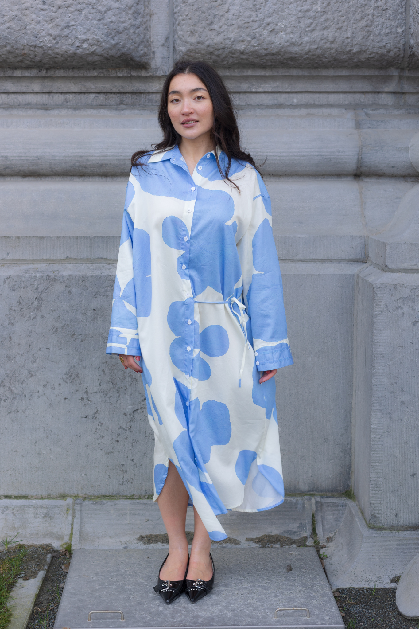 Model wearing the JIJI ninon dress in white and blue flower. Front view