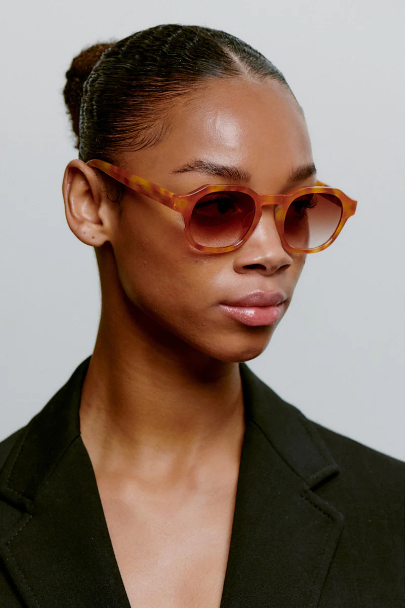 Model wearing the A. Kjaerbede zan sunglasses in burnt amber / orange. Front view