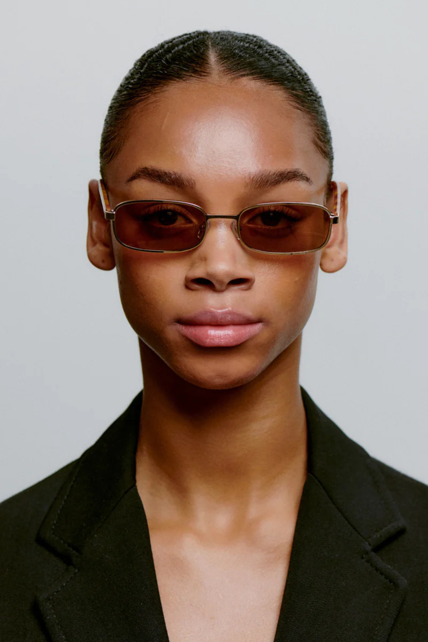 Model wearing the A. Kjaerbede noah sunglasses in gold burnt amber. Front view