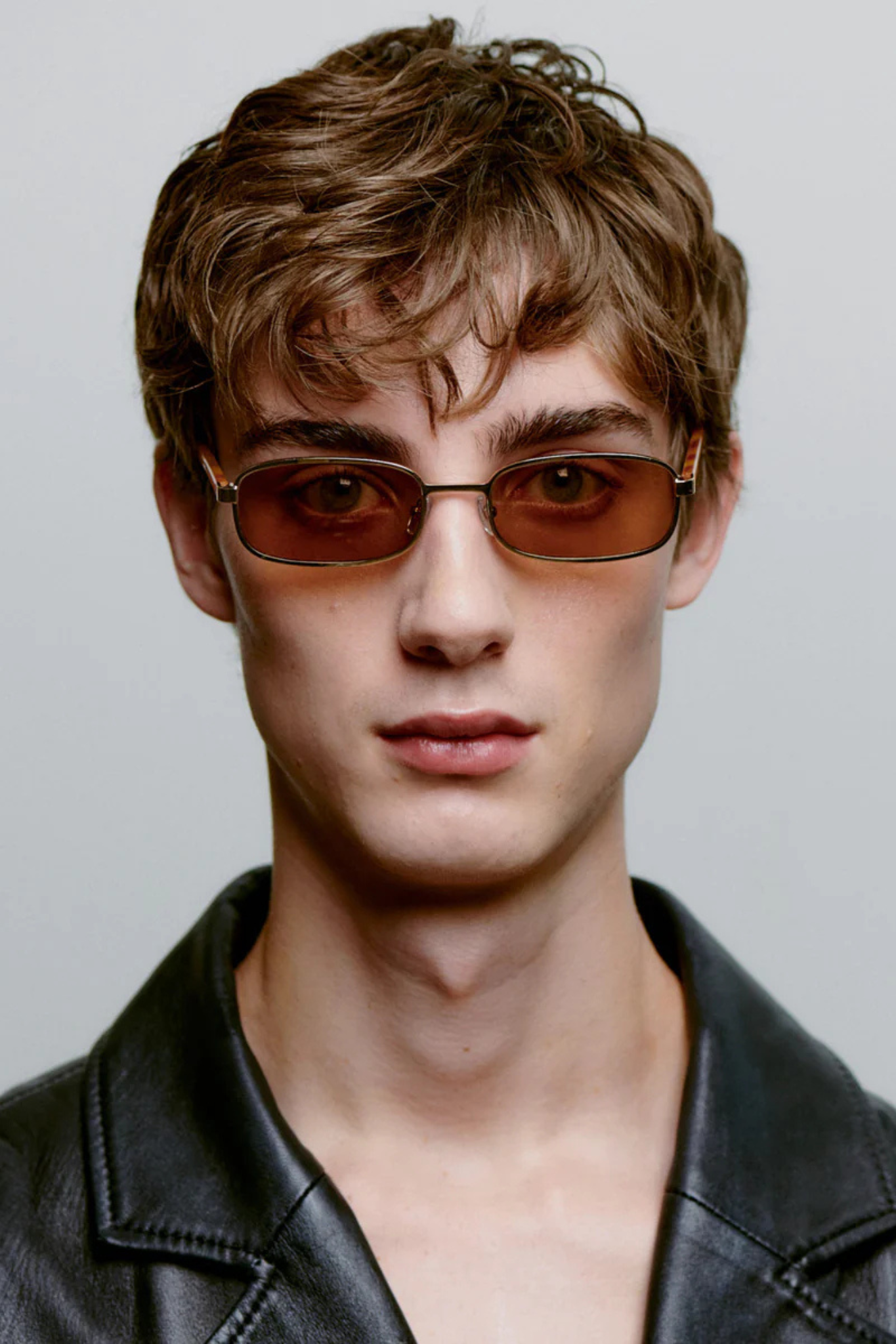 Model wearing the A. Kjaerbede noah sunglasses in gold burnt amber. Front view