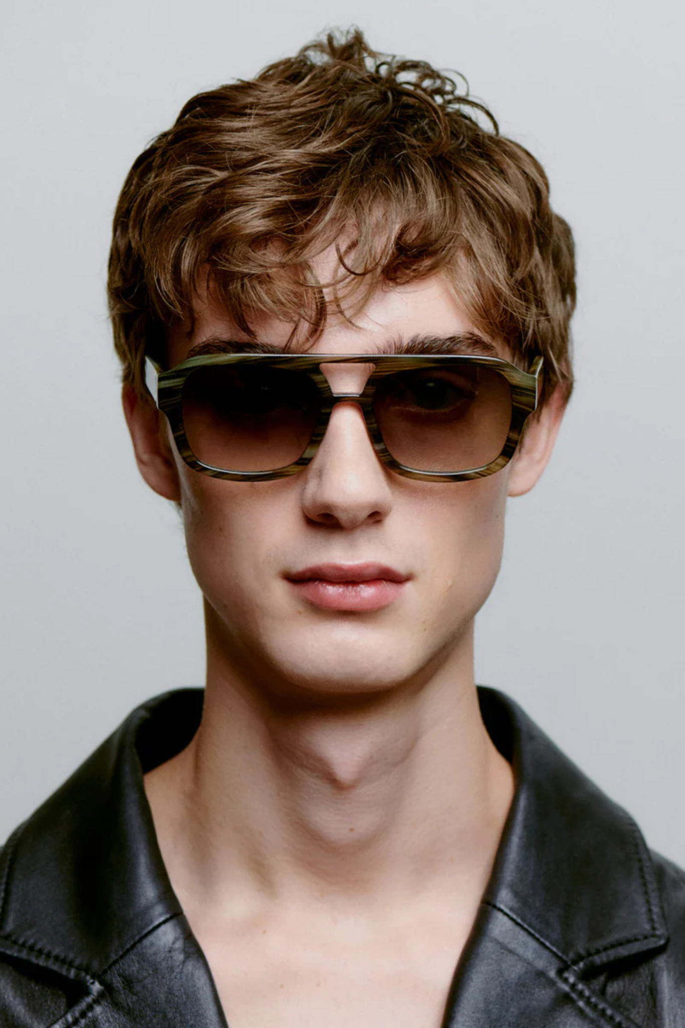 Model wearing the A. Kjaerbede kaya sunglasses in striped horn. Front view