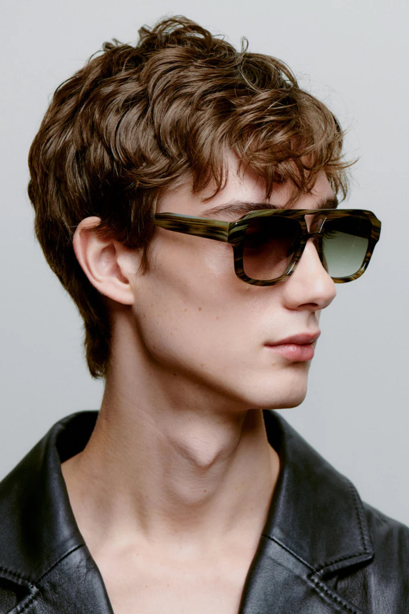 Model wearing the A. Kjaerbede kaya sunglasses in striped horn. Side view