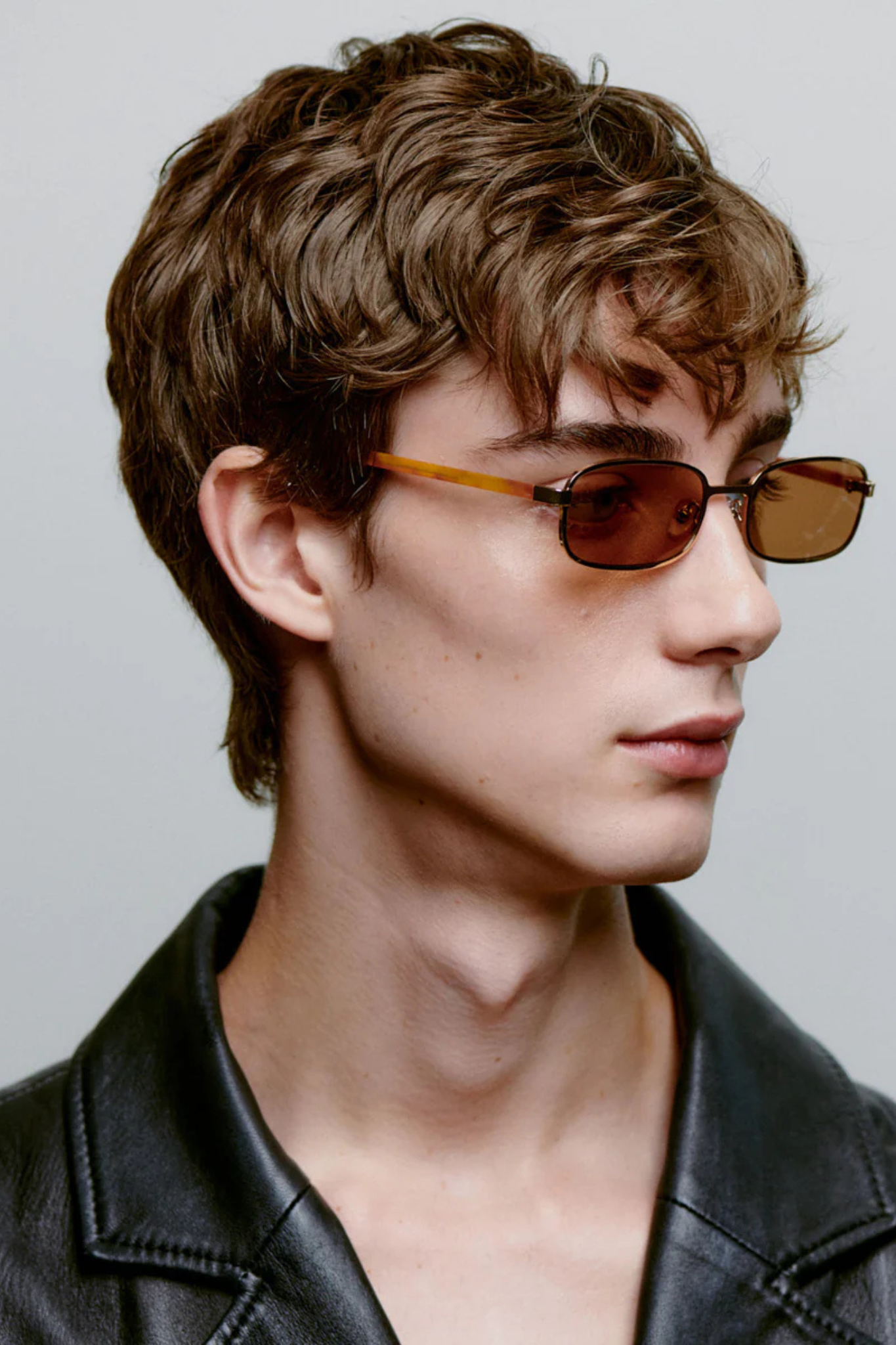 Model wearing the A. Kjaerbede noah sunglasses in gold burnt amber. Side view