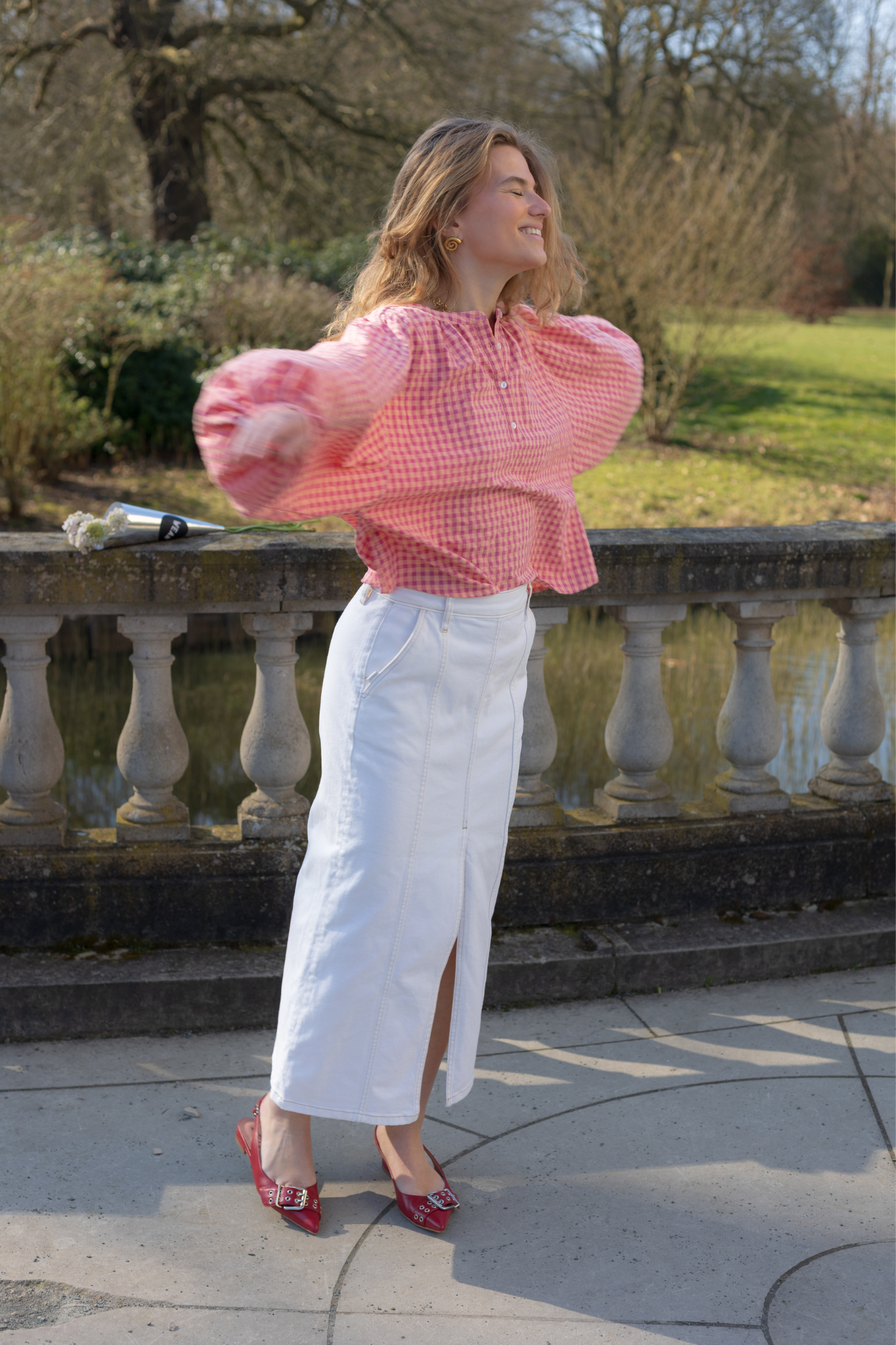 Model wearing the Fabienne Chapot dominique skirt in white. Side view